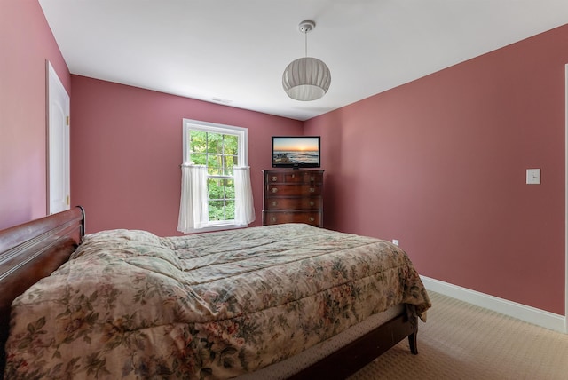 bedroom featuring carpet and baseboards