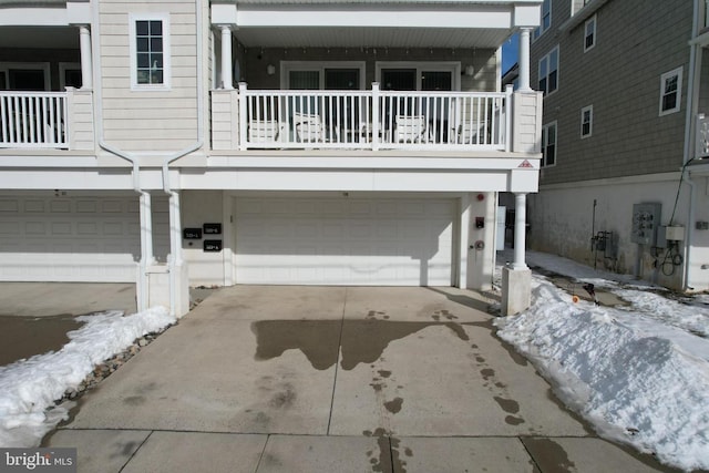 view of front of home with a balcony and a garage