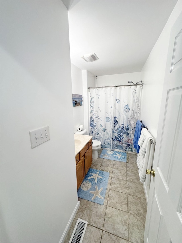 bathroom featuring tile patterned floors, walk in shower, vanity, and toilet