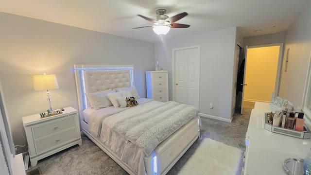 bedroom featuring ceiling fan, a closet, and light colored carpet