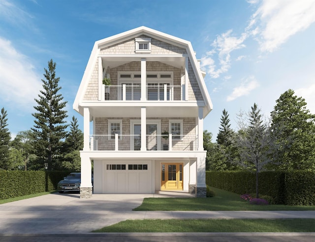 view of front of house featuring a garage and a balcony