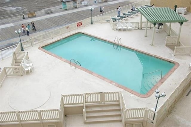 community pool with a patio and stairway