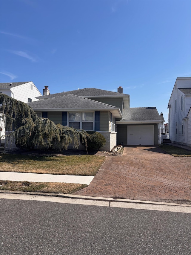 7 Kingston Ln, Ocean City, NJ 08226 - view of front of home with a garage, decorative driveway, and a chimney