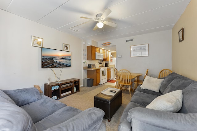 living room featuring ceiling fan and light colored carpet