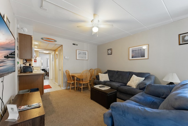 living room with ceiling fan and light colored carpet