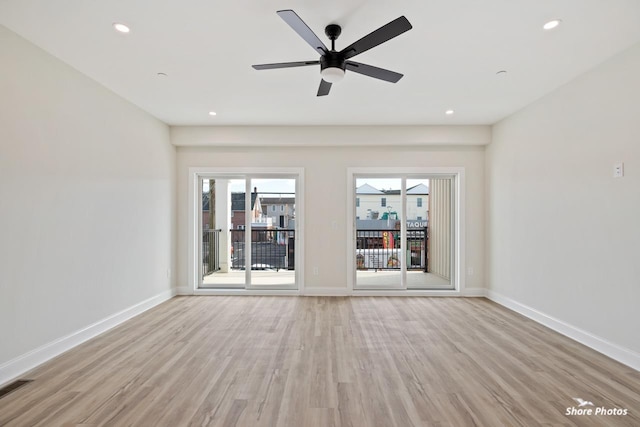 spare room with light wood-style floors, baseboards, and recessed lighting