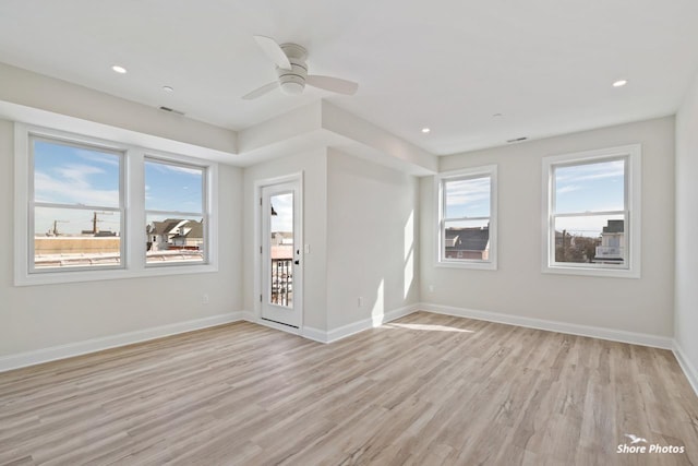 empty room with plenty of natural light, light wood-style floors, ceiling fan, baseboards, and recessed lighting