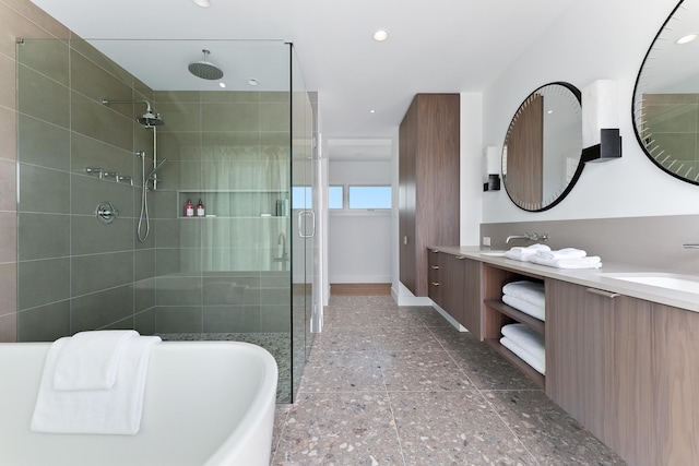 bathroom featuring vanity and separate shower and tub