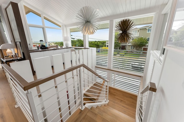 staircase featuring hardwood / wood-style flooring, lofted ceiling, and wood ceiling