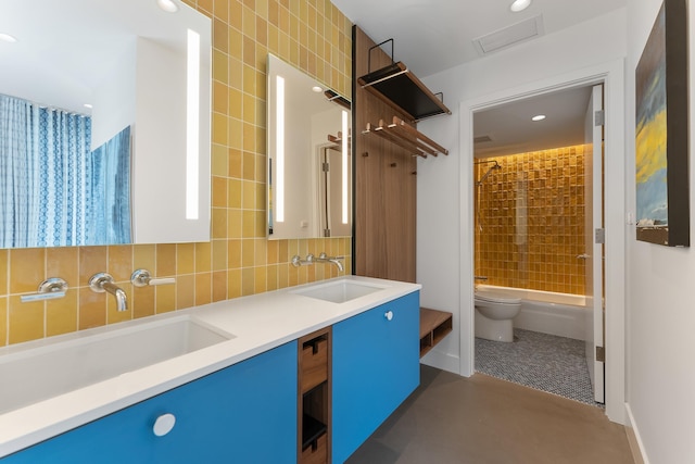 full bathroom featuring vanity, toilet,  shower combination, and tile walls