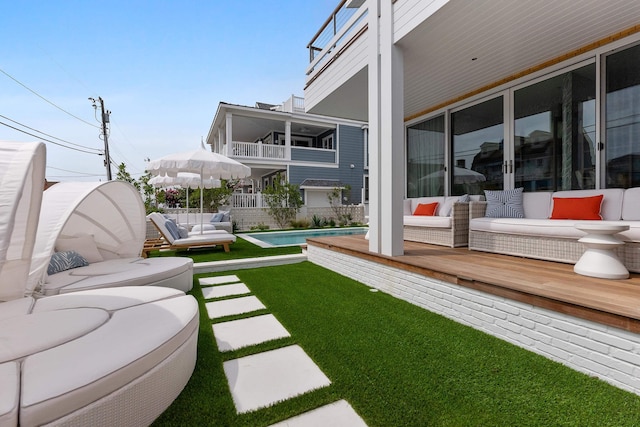 view of yard with an outdoor living space, a patio, and a swimming pool side deck