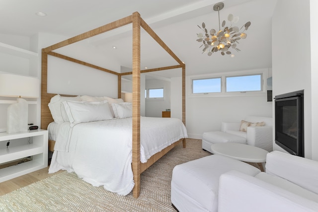 bedroom featuring hardwood / wood-style flooring and a chandelier