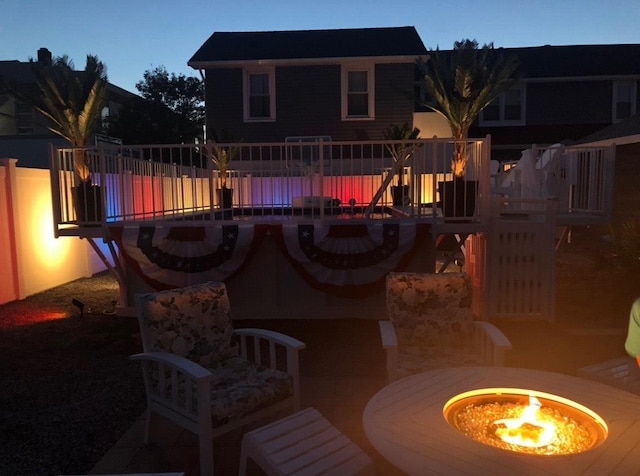 view of pool with fence and a fire pit