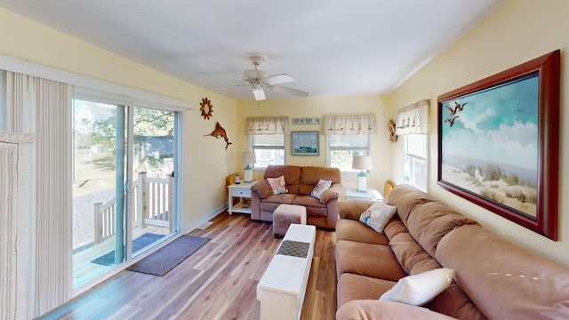 living room with light hardwood / wood-style flooring and ceiling fan