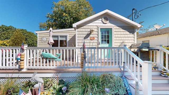 rear view of house featuring a deck