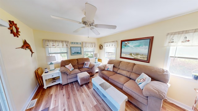 living room with ceiling fan and light hardwood / wood-style floors