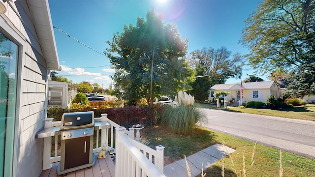 exterior space with grilling area and a lawn