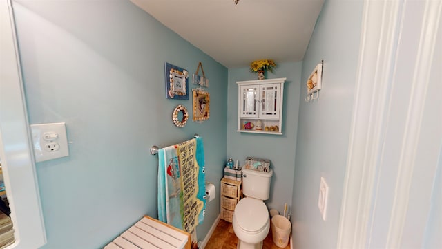 bathroom with hardwood / wood-style floors and toilet