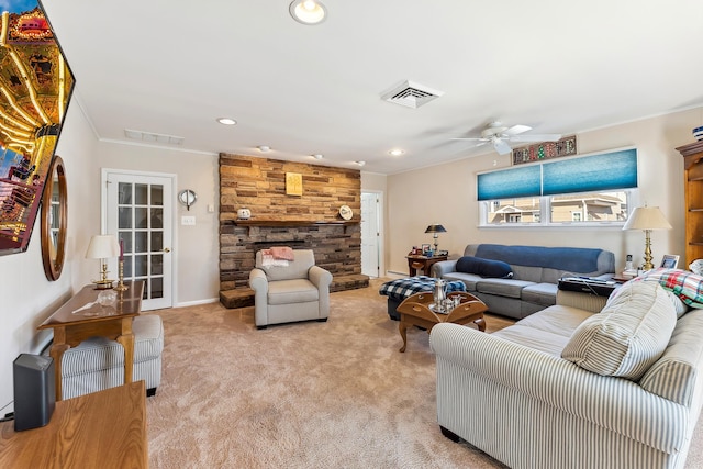 living room featuring light carpet, a stone fireplace, ornamental molding, and ceiling fan