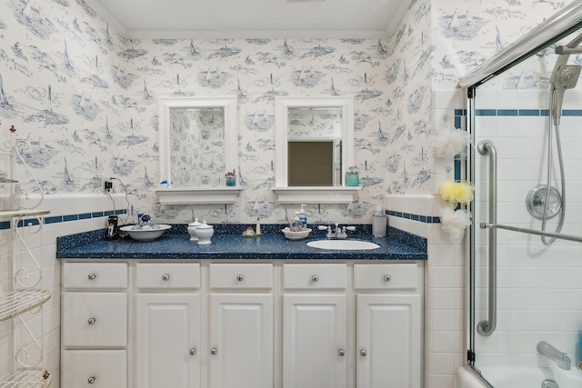 bathroom featuring vanity and bath / shower combo with glass door