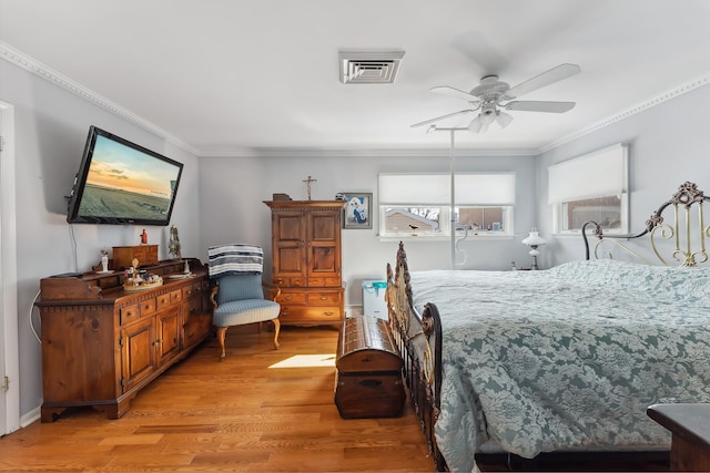 bedroom featuring crown molding and light wood-type flooring