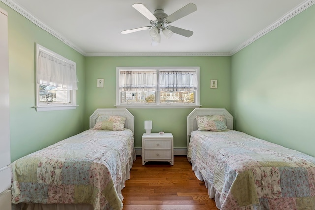 bedroom featuring crown molding, a baseboard radiator, ceiling fan, and hardwood / wood-style floors