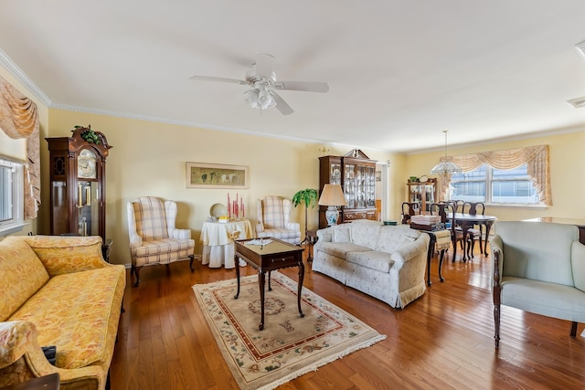 living room featuring ornamental molding, ceiling fan, and dark hardwood / wood-style flooring