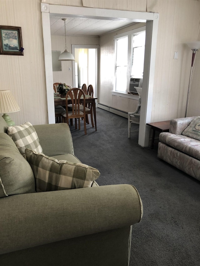 carpeted living room featuring baseboard heating and cooling unit