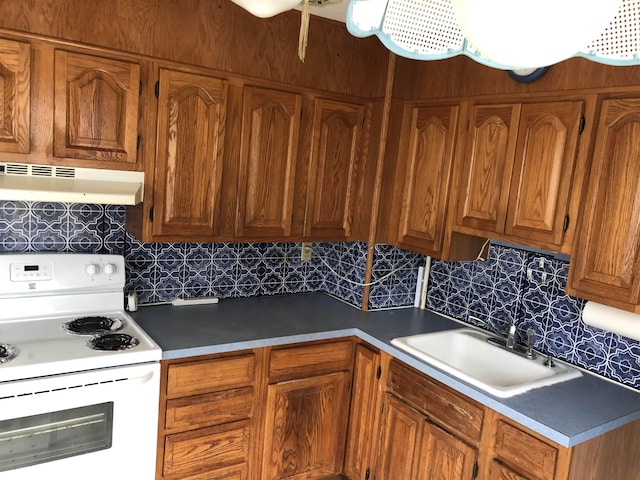 kitchen with decorative backsplash, sink, and electric stove