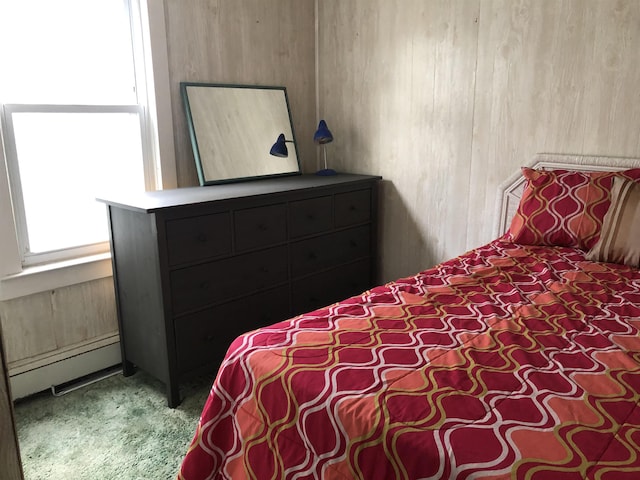 carpeted bedroom with a baseboard radiator