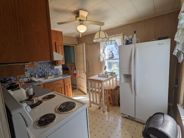 kitchen featuring pendant lighting, white appliances, sink, ceiling fan, and a baseboard radiator