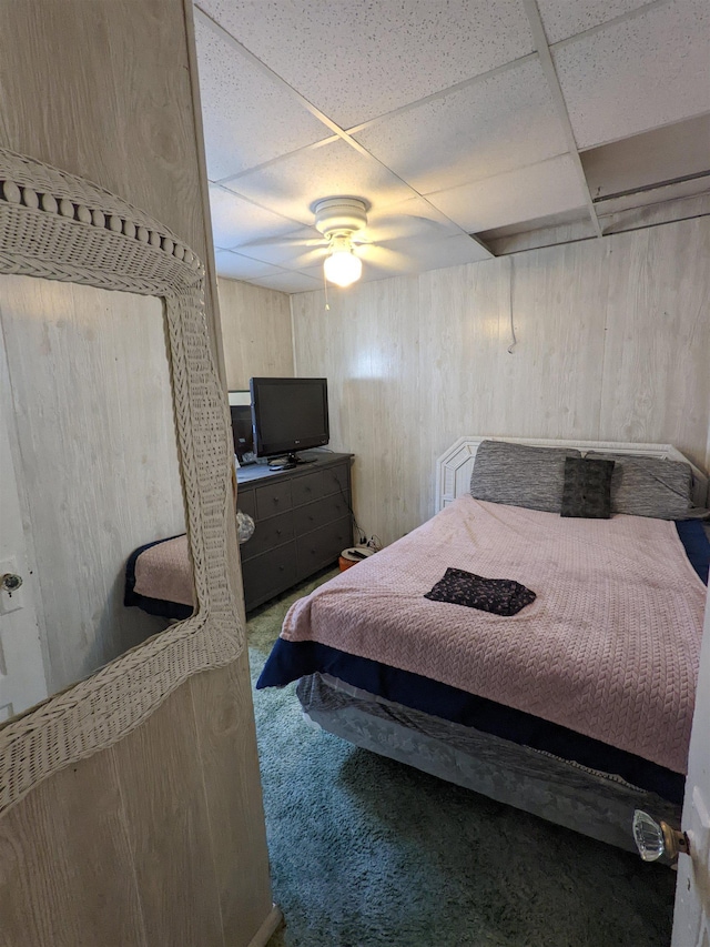 carpeted bedroom featuring a paneled ceiling and ceiling fan