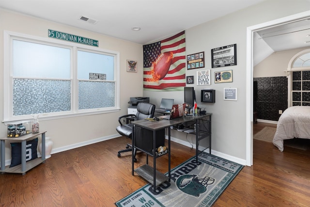 office area featuring baseboards, visible vents, and wood finished floors