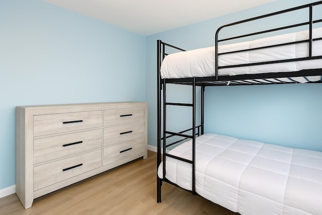 unfurnished bedroom featuring baseboards and light wood finished floors