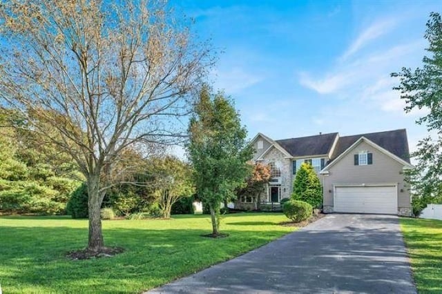 view of front of home featuring a garage and a front lawn