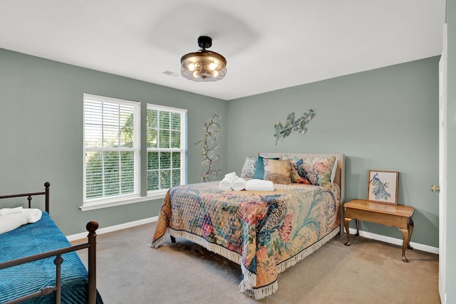 bedroom featuring light carpet