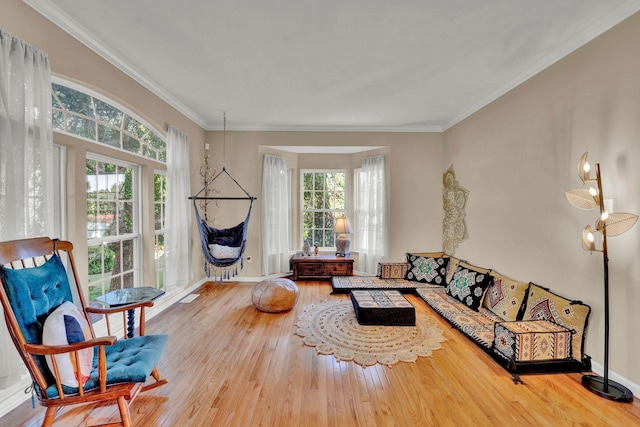 living room with hardwood / wood-style flooring and crown molding