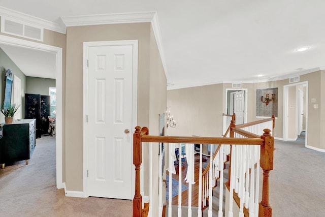 hall featuring crown molding and light carpet