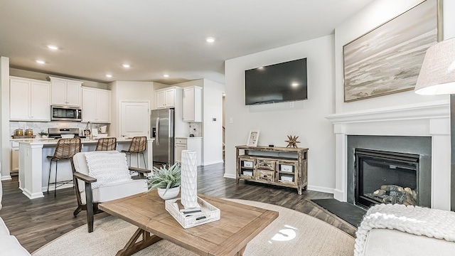 942 Carol Ave, Lower Township, NJ 08204 - living area featuring dark wood-style floors, recessed lighting, baseboards, and a fireplace with raised hearth