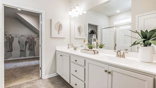 942 Carol Ave, Lower Township, NJ 08204 - bathroom with a shower stall, double vanity, tile patterned flooring, a spacious closet, and baseboards