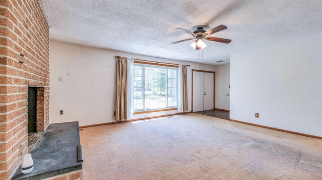 8 Sheila Ave, Seaville, NJ 08230 - unfurnished living room featuring a textured ceiling, ceiling fan, a brick fireplace, carpet flooring, and baseboards