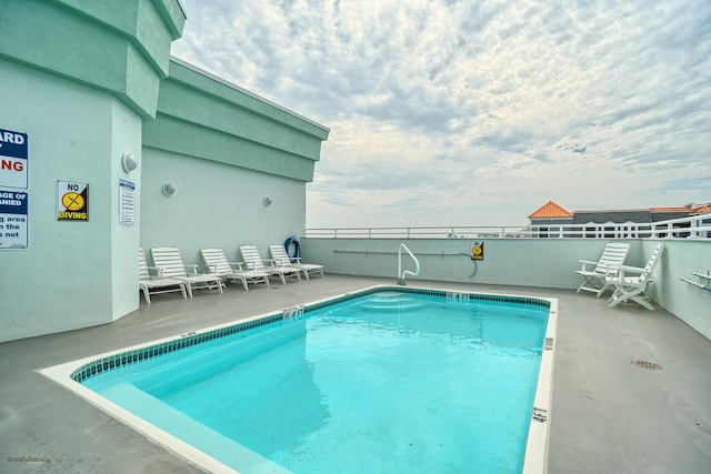 view of swimming pool with a patio area