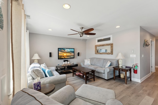 living room featuring ceiling fan and light wood-type flooring