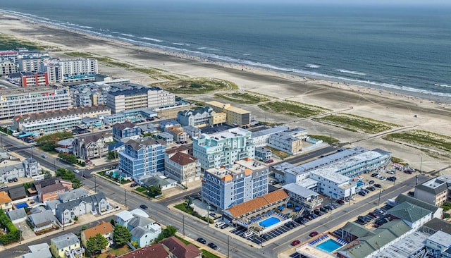 drone / aerial view featuring a view of the beach and a water view