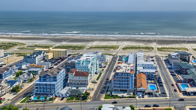 bird's eye view featuring a view of the beach and a water view