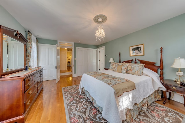 645 Hughes St, Cape May, NJ 08204 - bedroom with light wood-style flooring, a chandelier, and a closet