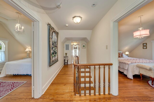 645 Hughes St, Cape May, NJ 08204 - corridor featuring light wood-style flooring, an upstairs landing, and a chandelier