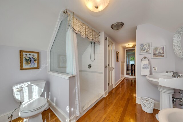 645 Hughes St, Cape May, NJ 08204 - bathroom featuring vaulted ceiling, a stall shower, and wood finished floors