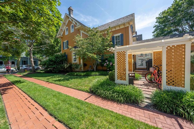 645 Hughes St, Cape May, NJ 08204 - exterior space featuring a lawn and a chimney
