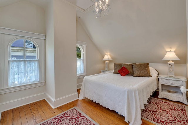 645 Hughes St, Cape May, NJ 08204 - bedroom with vaulted ceiling, multiple windows, and wood finished floors